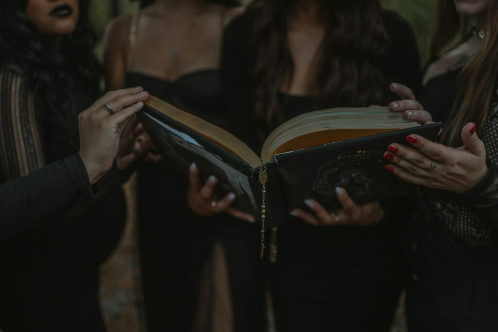 1692 they missed one meaning - group of witches holding book open